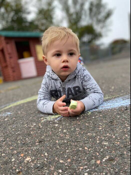 Toddler playing with chalk