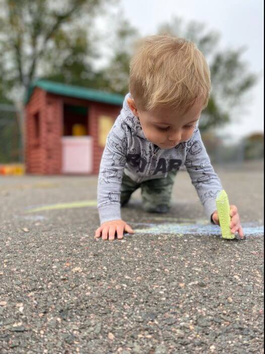 Toddler playing with chalk